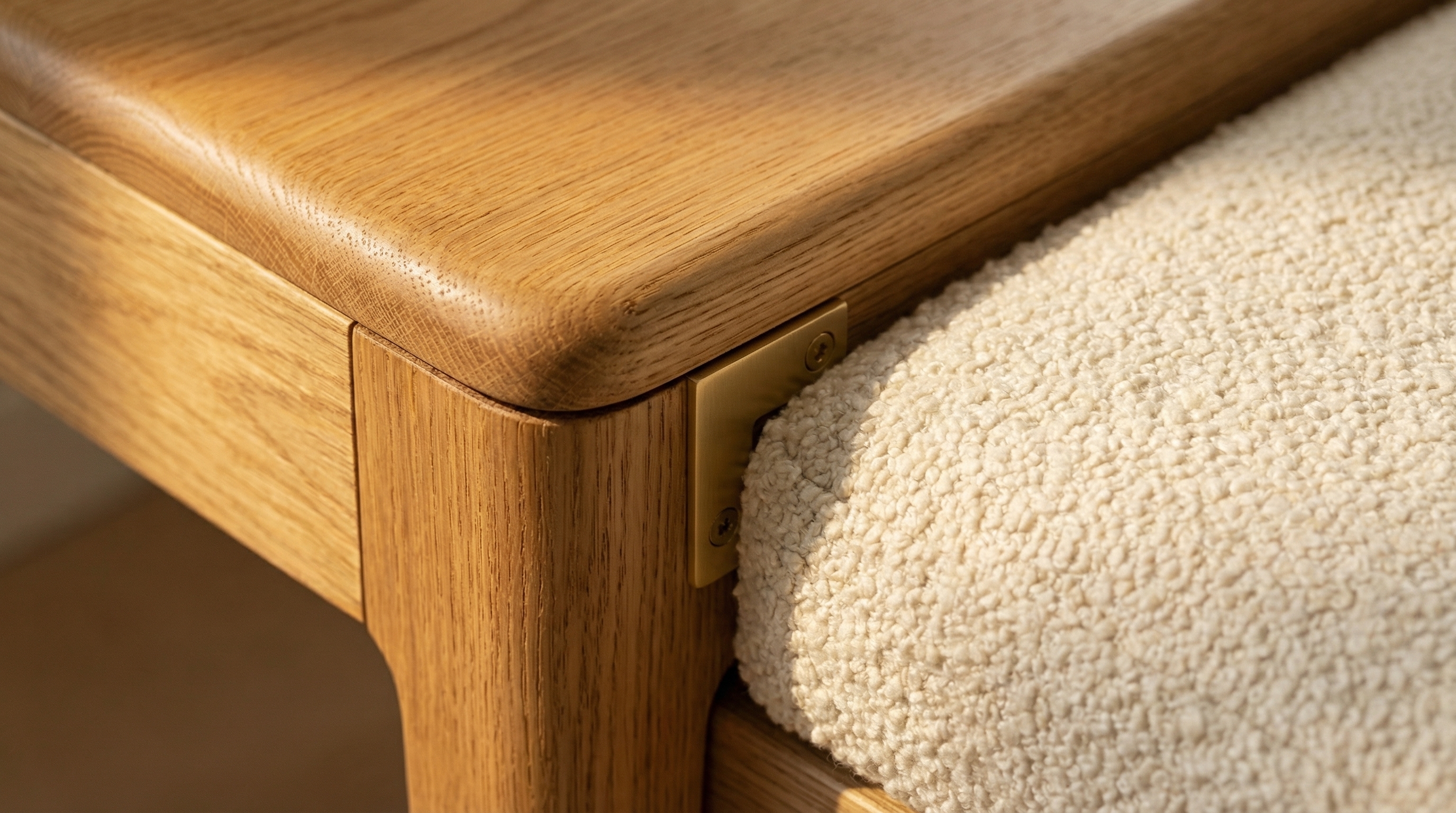Close-up of walnut, bouclé and brass meeting